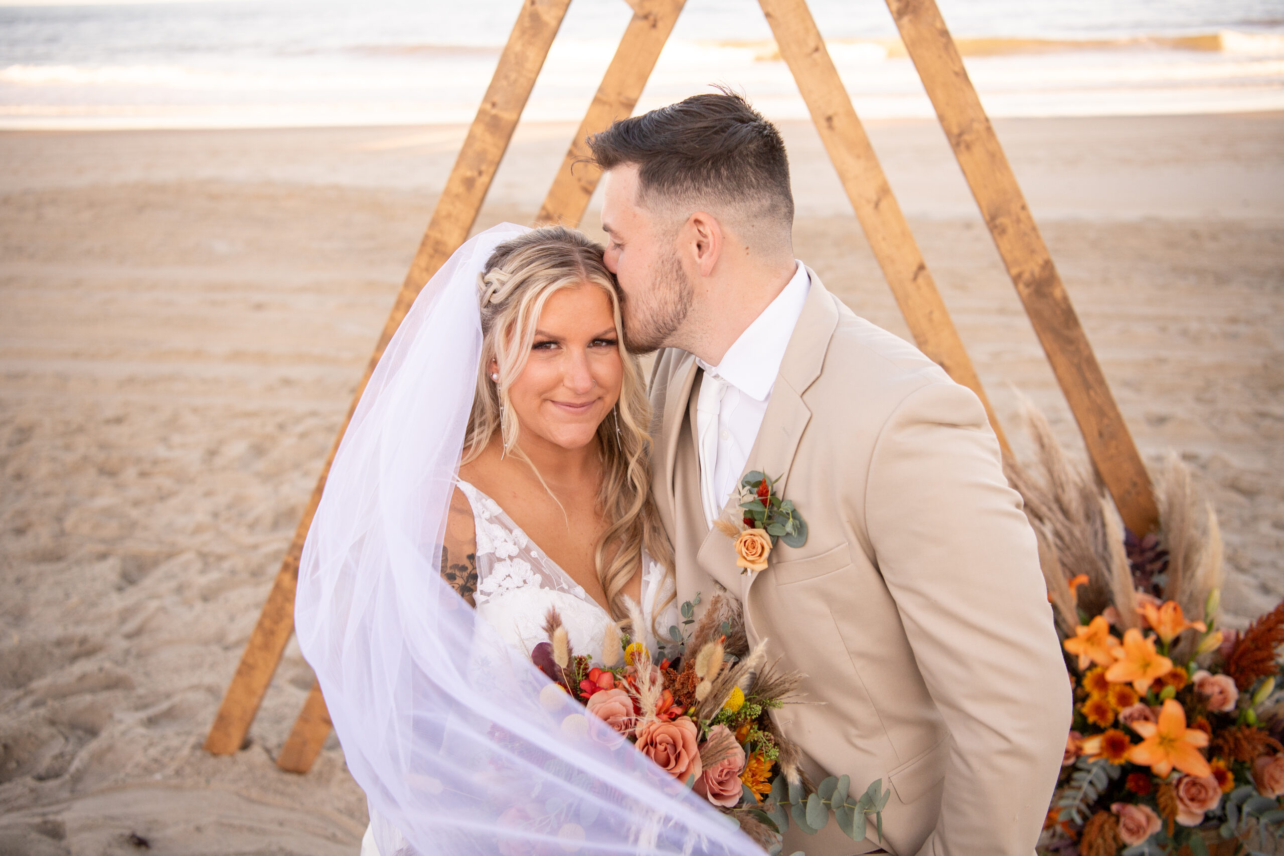 OBX Couple shares kiss on beach after their OBX Wedding