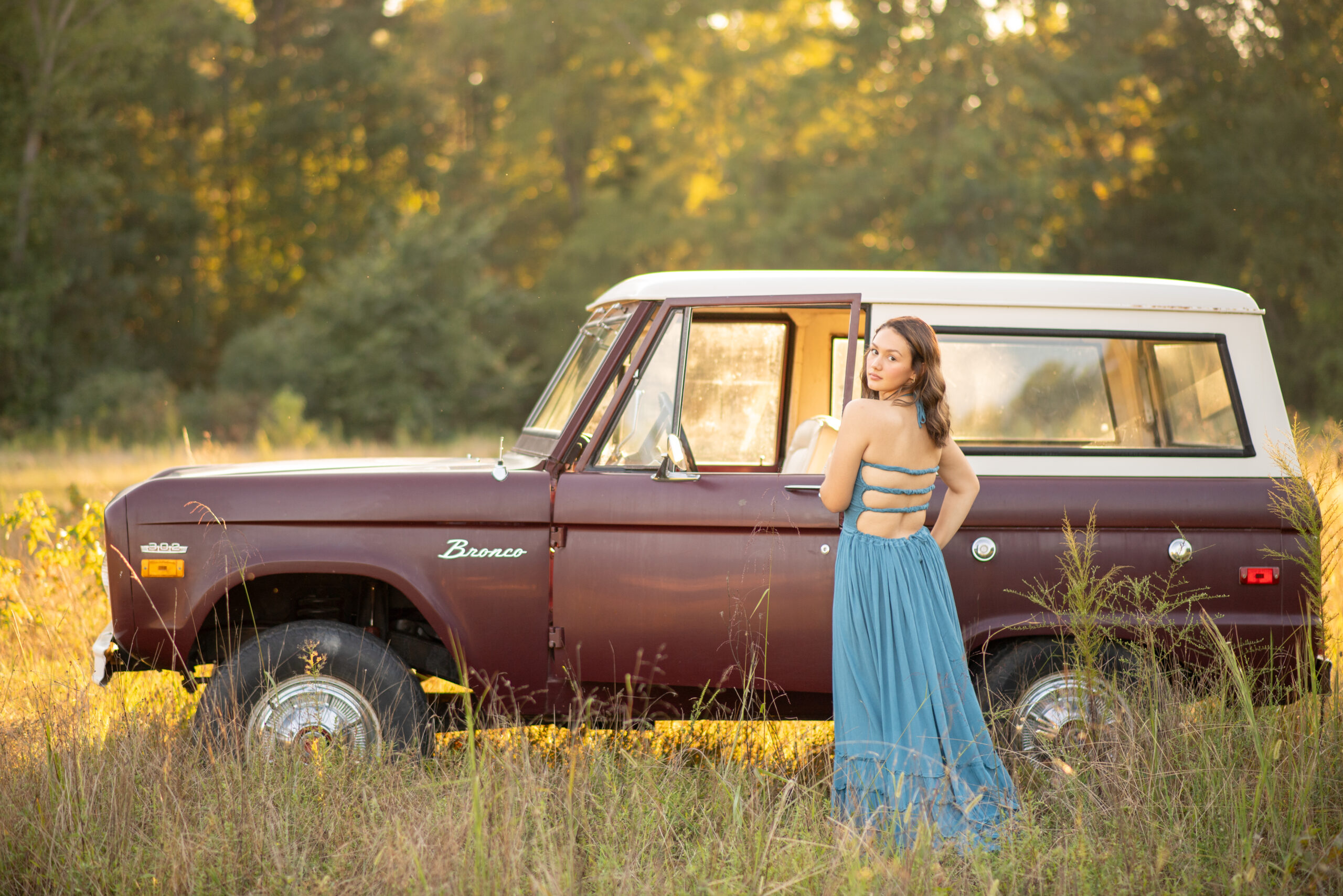 Vintage Bronco with golden light and beautiful girl