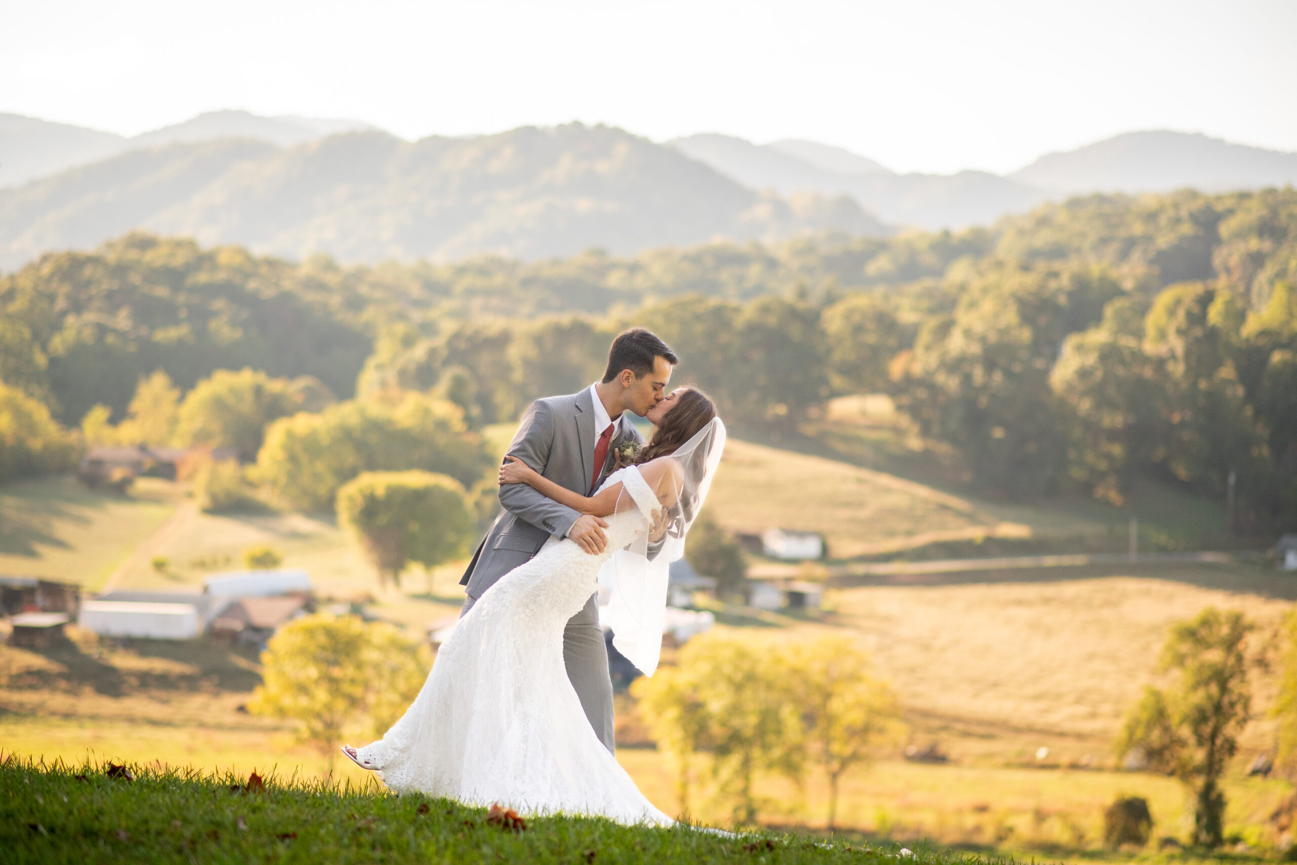 Groom dipping Bride with beautiful NC Mountains in the background.