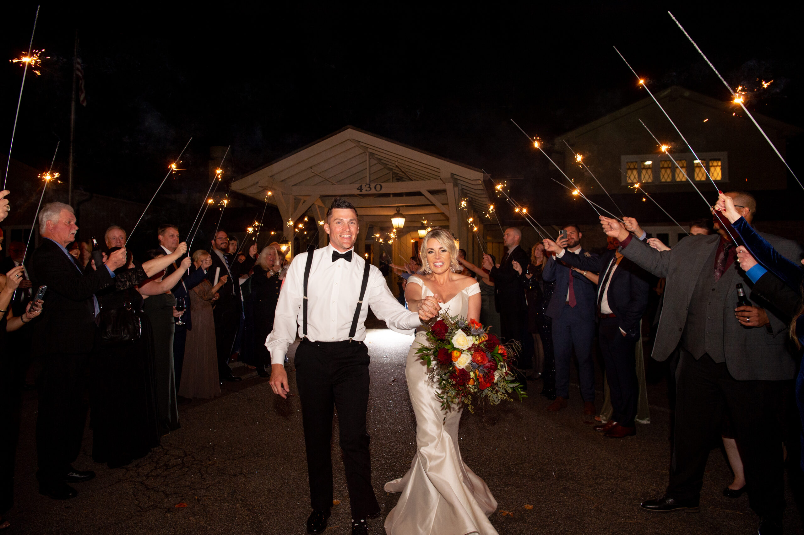 Bride and Groom walk through sparklers at MacGregor Downs Country Club in Cary, NC